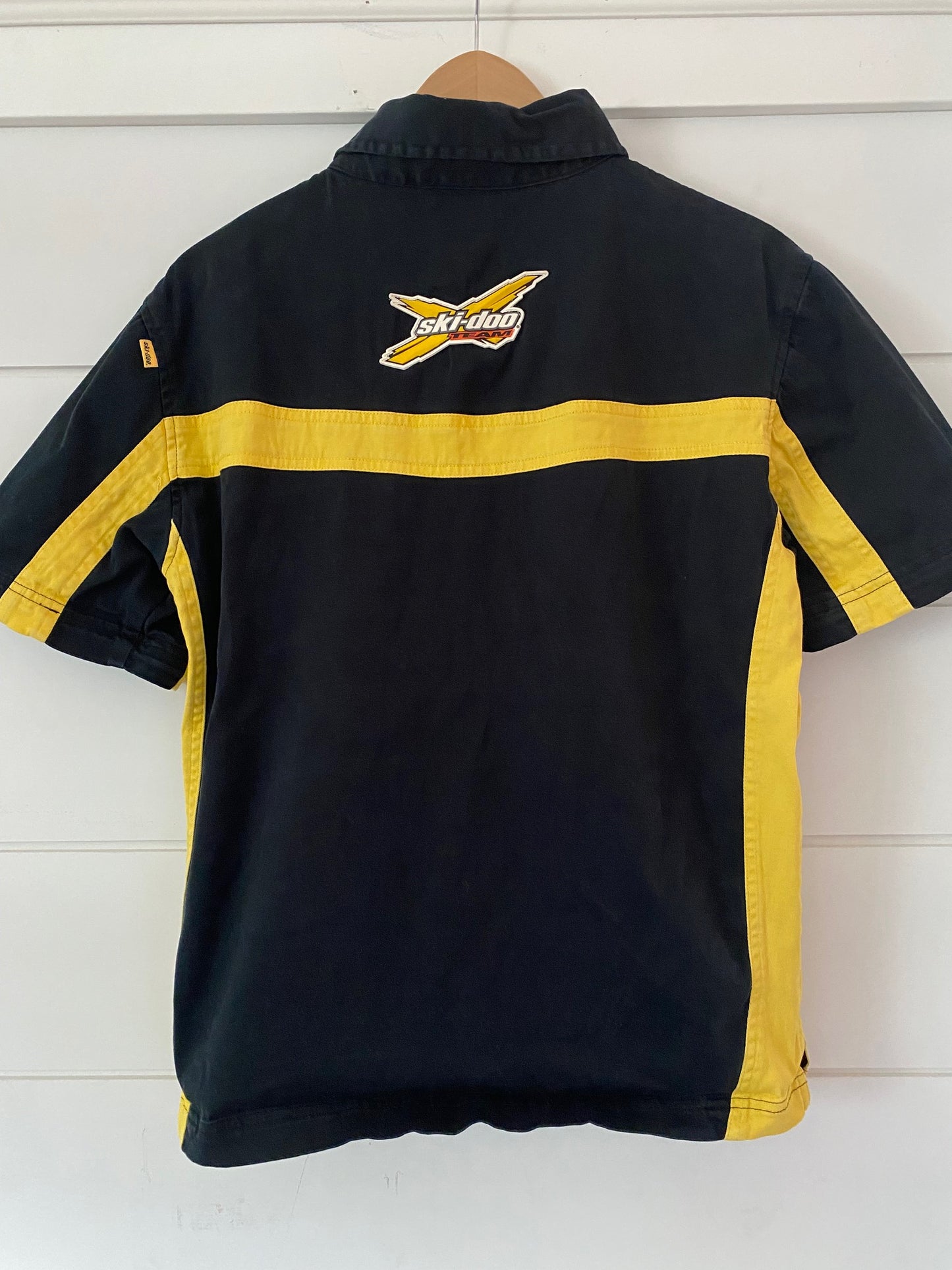 back view of a black and yellow shirt with the logo ski-doo