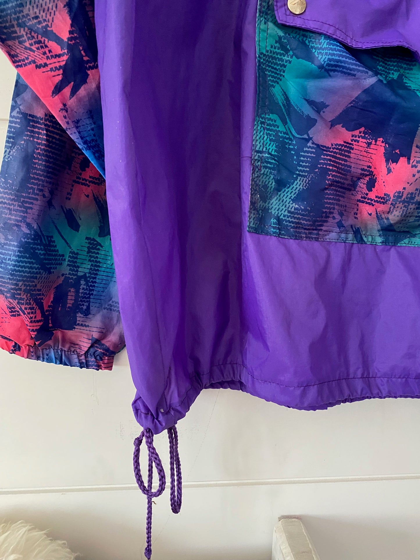 purple k-way with waist laces