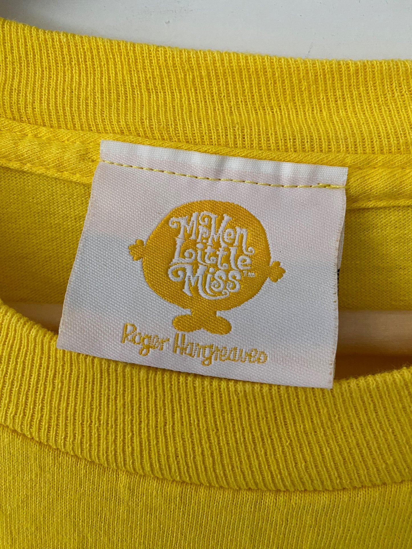 tag on a yello t-shirt mr. men little miss tm roger hangreaves