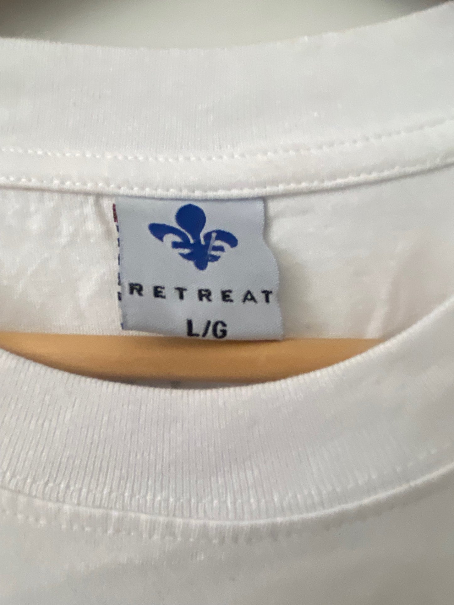 retreat tag size large with a blue fleur de lys