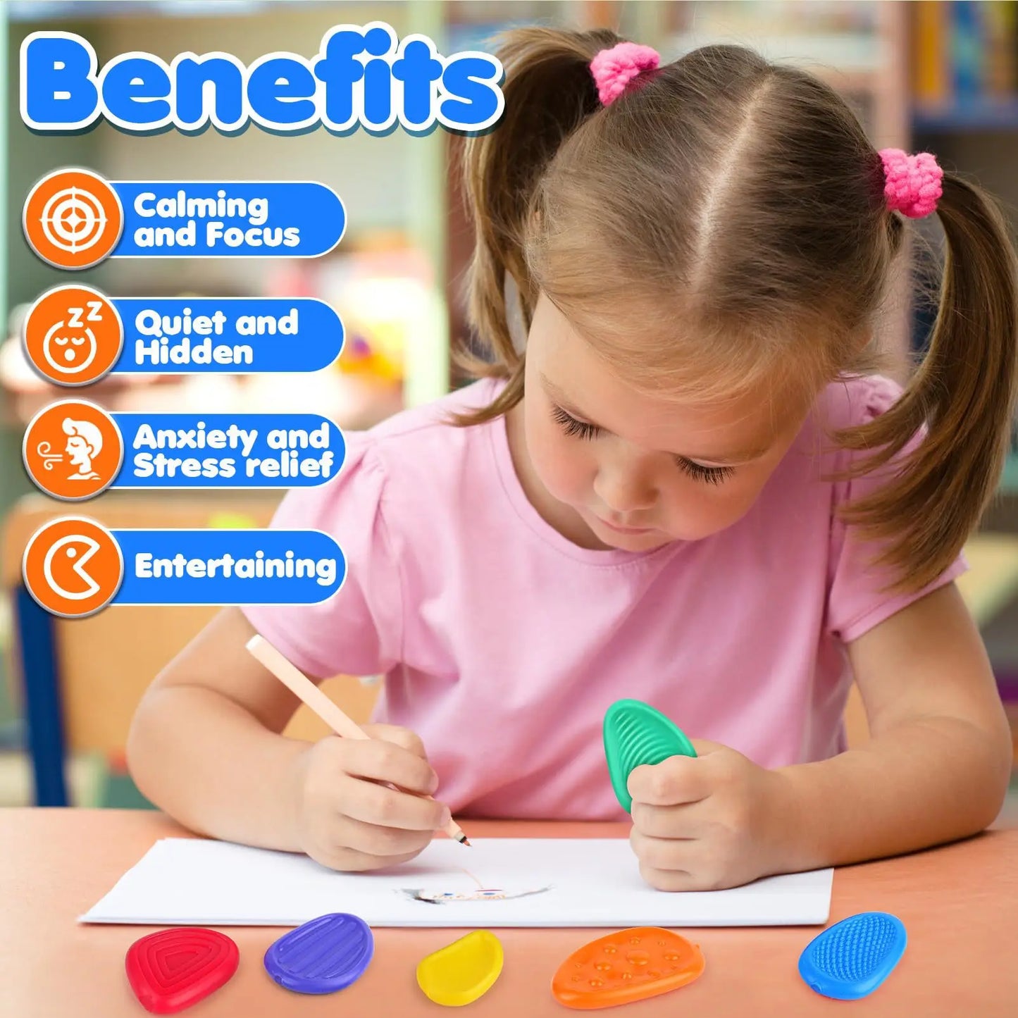 little girl writing on a paper holding texture toy,