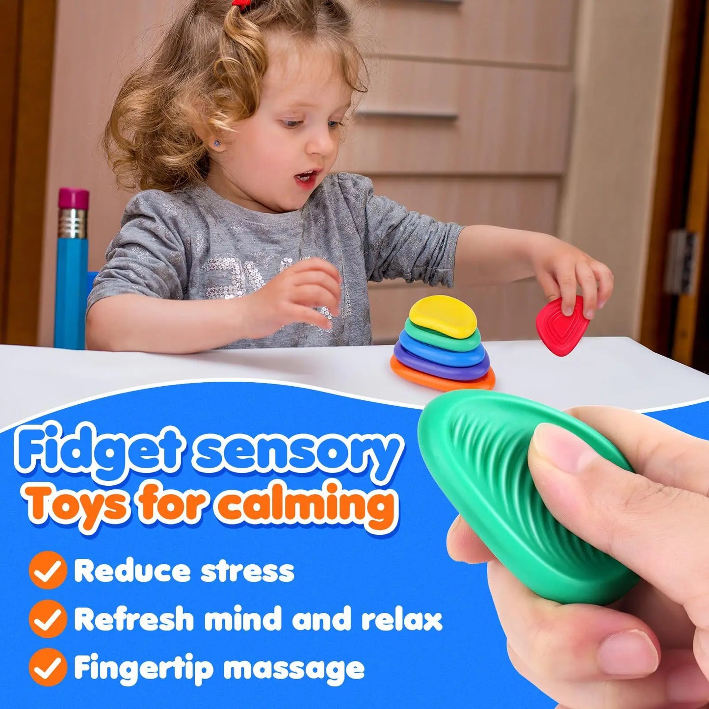 child girl playing with rubber toys on a table,