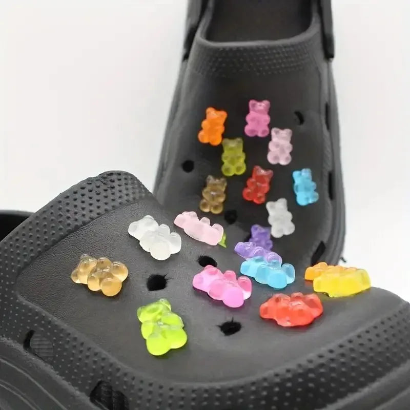 different colors gummies bears on a black croc pair of shoes