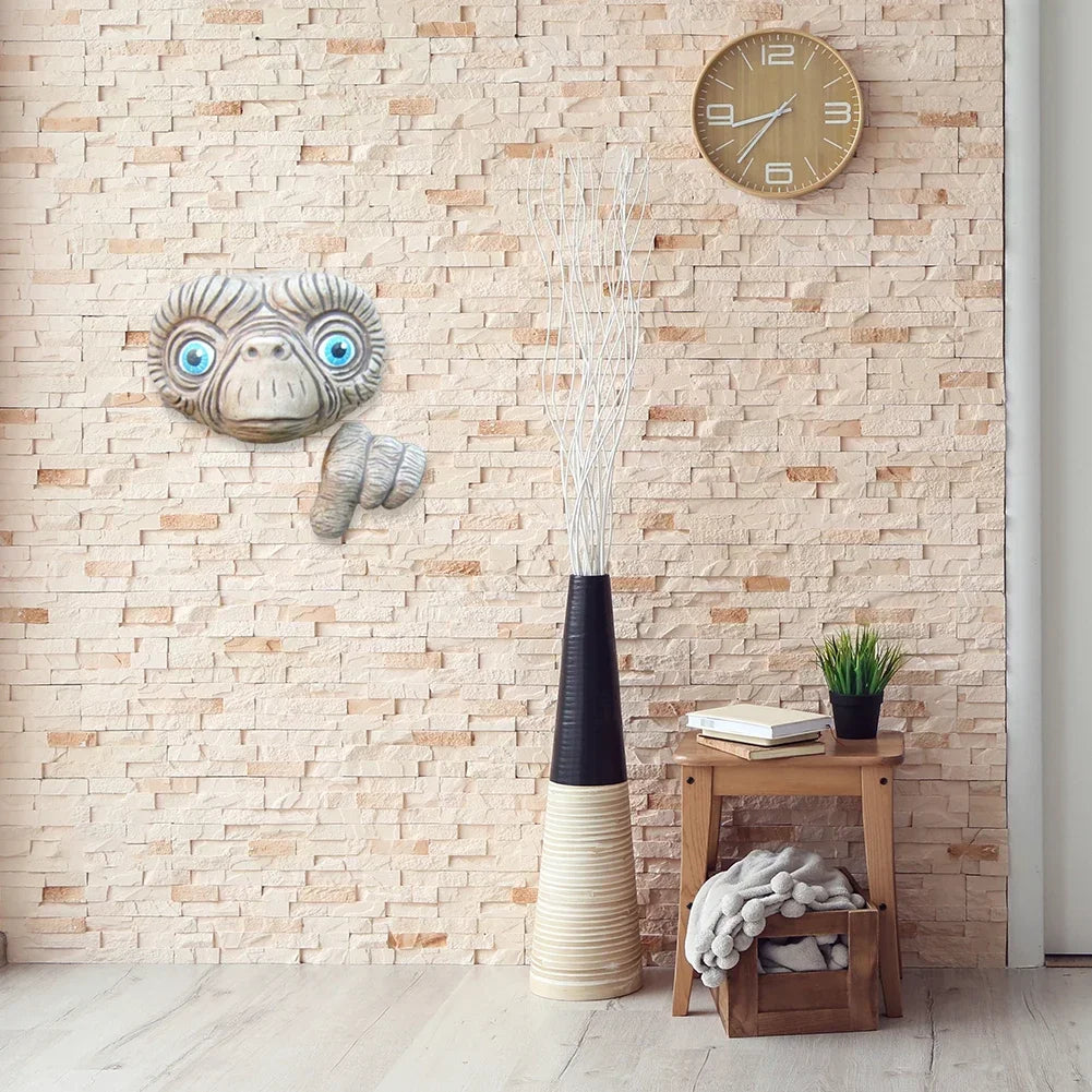 E.T. statue hanging on a wall inside