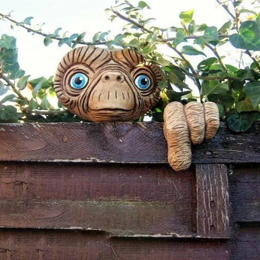 E.T. statue on a wooden fence