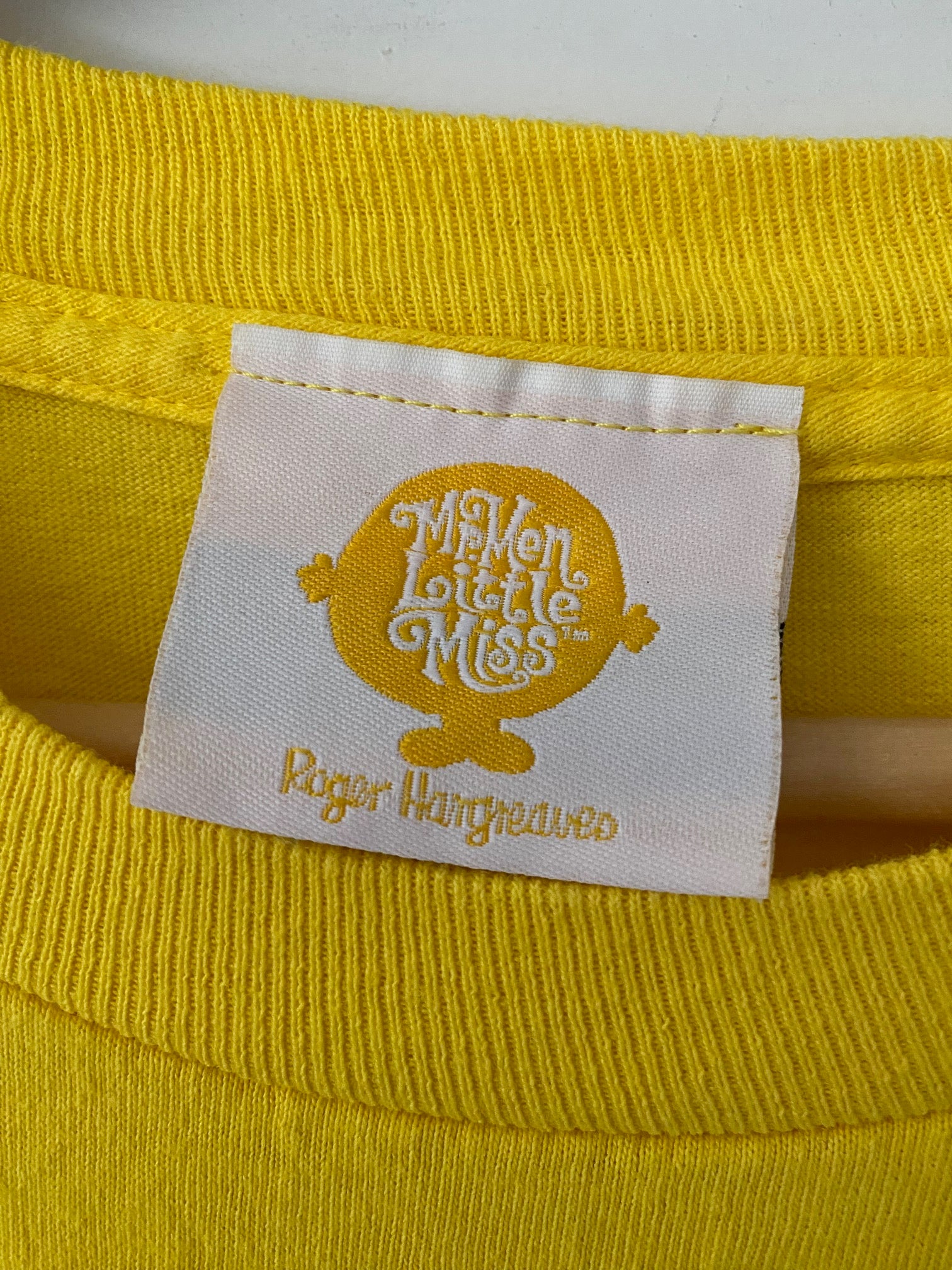 tag on a yello t-shirt mr. men little miss tm roger hangreaves