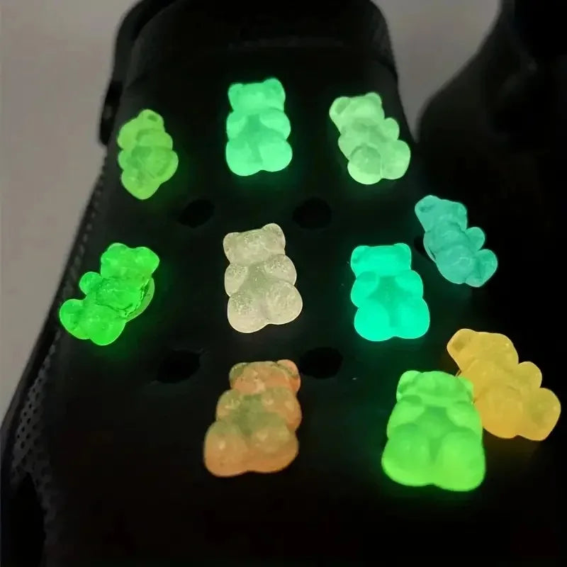 glow in the dark different colors gummies bears on a black croc pair of shoes