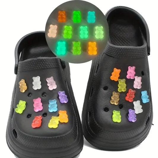 different colors gummies bears on a black croc pair of shoes